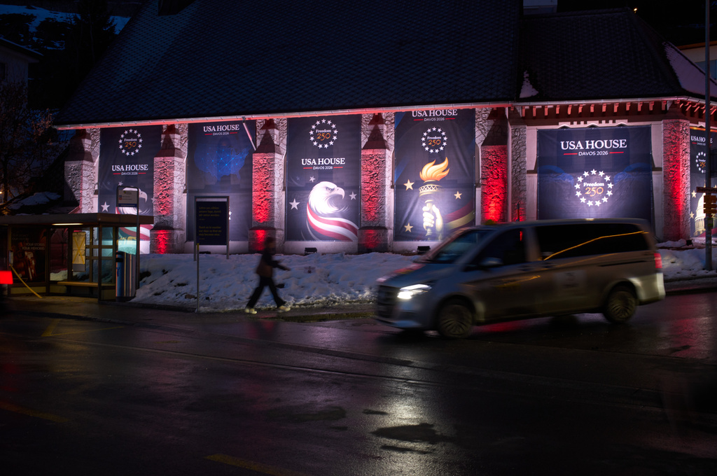 The USA House is illuminated at the eve of the start of the Annual Meeting of the World Economy Forum in Davos, Switzerland, Sunday, Jan. 18, 2026. (AP Photo/Markus Schreiber)