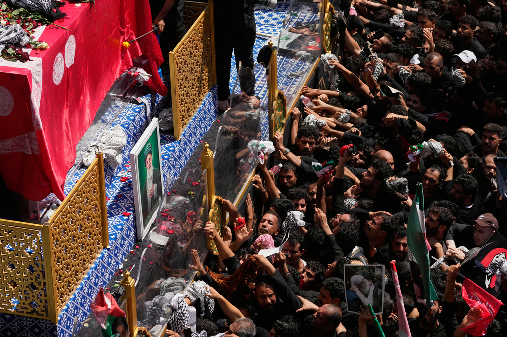 Mourners reach toward a truck carrying the coffin of Iranian Supreme Leader Ayatollah Ali Khamenei during a funeral procession in Najaf, Iraq, Wednesday, July 8, 2026. (AP Photo/Hadi Mizban)