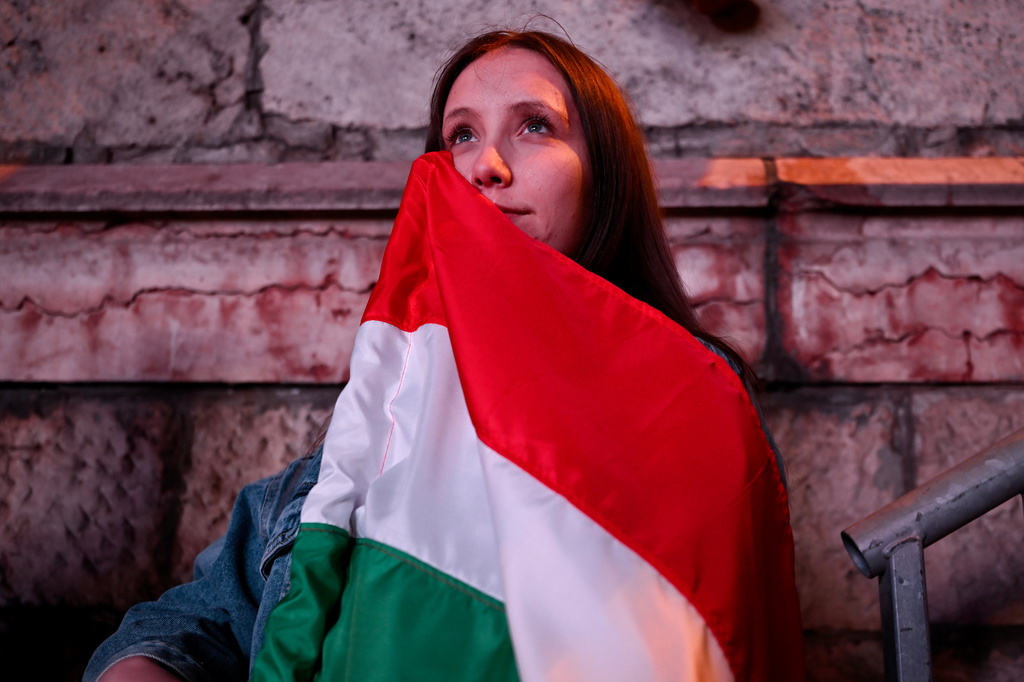Woman reacts in the streets after the announcement of partial results of the Hungarian parliamentary election in Budapest, Hungary, Sunday, April 12, 2026. (AP Photo/Denes Erdos)