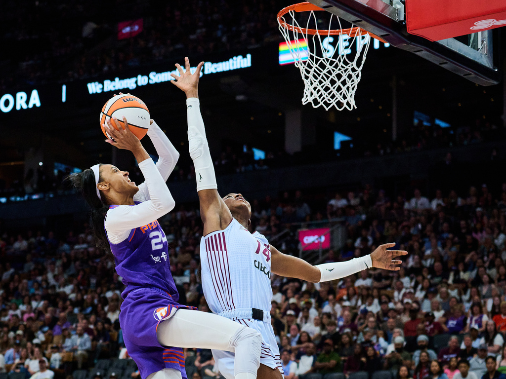 Phoenix Mercury's DeWanna Bonner (24) drives to the net past Toronto Tempo's Temi Fagbenle (14) during first half of an WNBA basketball game in Toronto, on Saturday, June 27, 2026. (Sammy Kogan /The Canadian Press via AP)