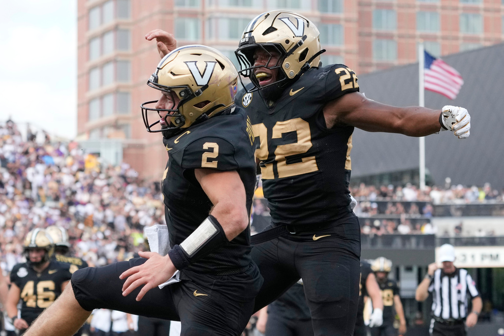 Vanderbilt quarterback Diego Pavia (2) celebrates his touchdown with running back Makhilyn Young (22) during the second half of an NCAA college football game against LSU, Saturday, Oct. 18, 2025, in Nashville, Tenn. (AP Photo/George Walker IV)