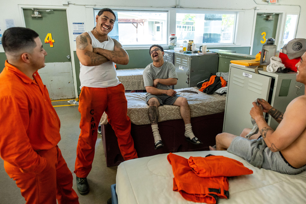 Inmates socialize at the Pine Grove Youth Conservation Camp, July 14, 2025, in Red Corral, Calif. (AP Photo/Ethan Swope)