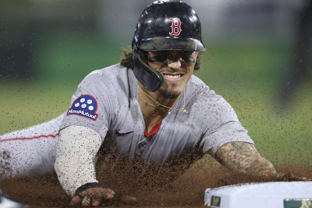 Boston Red Sox's Jarren Duran slides into third base for a steal during the fifth inning of a baseball game against the Athletics, Monday, Sept. 8, 2025, in West Sacramento, Calif. (AP Photo/Scott Marshall)