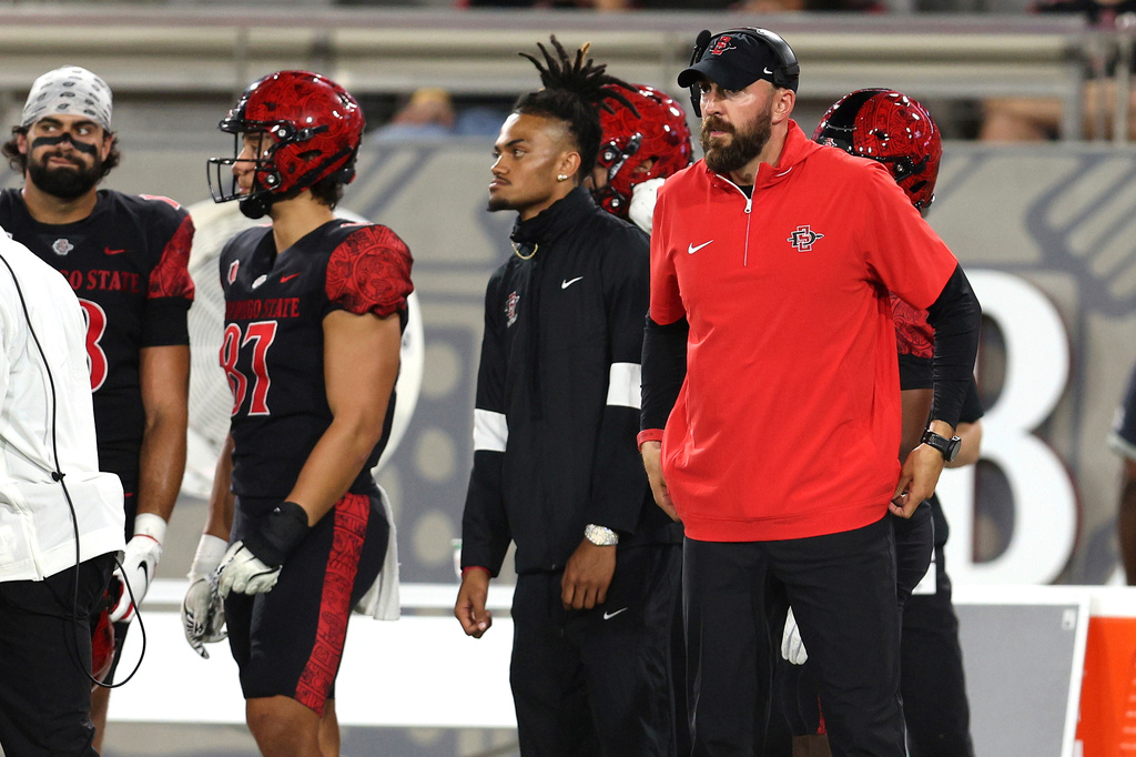 FILE - San Diego State head coach Sean Lewis, right, looks on during the first half of an NCAA college football game against Oregon State, Sept. 7, 2024, in San Diego. (AP Photo/Raul Romero Jr., File)