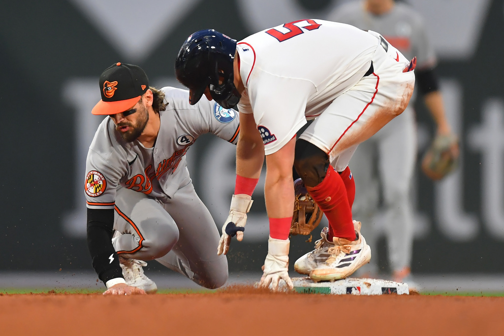 Baltimore Orioles second baseman Blaze Alexander, left, and Boston Red Sox's Caleb Durbin, right, collide as Durbin arrives safe at second on his double hit in the fifth inning of a baseball game, Tuesday, June 2, 2026, in Boston. (AP Photo/Steven Senne)