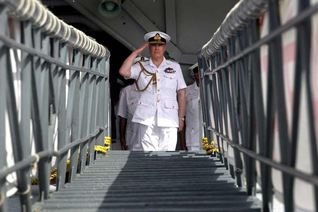 FILE - Britain's Prince Andrew, the Duke of York, salutes during his visit on the Indian aircraft carrier INS Viraat at the Western Naval Command in Mumbai, India, Wednesday, May 2, 2012. (AP Photo/Rajanish Kakade, file)