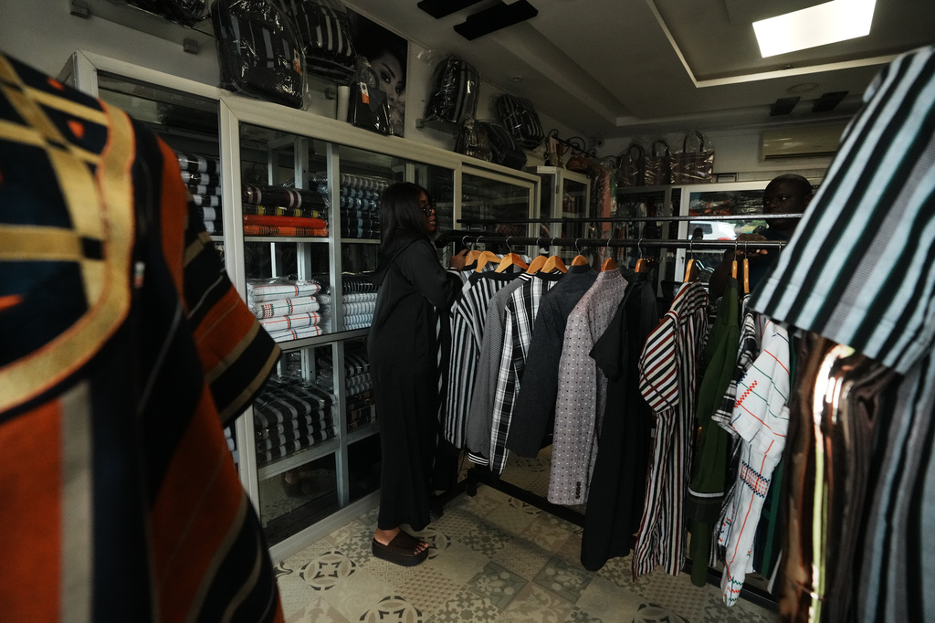 Fatoumata Dosso, the founder of DAF Collection, shows her Made in Benin clothes inside her showroom in Parakou, northern Benin, Saturday, May 16, 2026. (AP Photo/Sunday Alamba)
