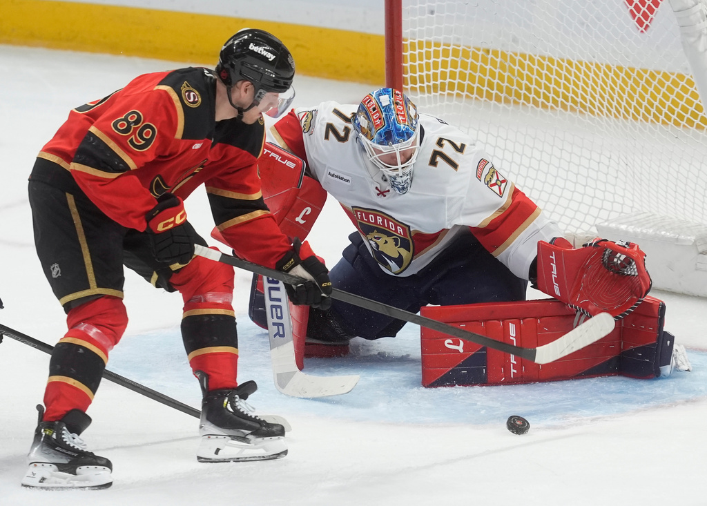 Ottawa Senators' Lars Eller (89) tries to get the puck past Florida Panthers goaltender Sergei Bobrovsky (72) during the second period of an NHL game in Ottawa, Thursday, April 9, 2026. (Adrian Wyld/The Canadian Press via AP)
