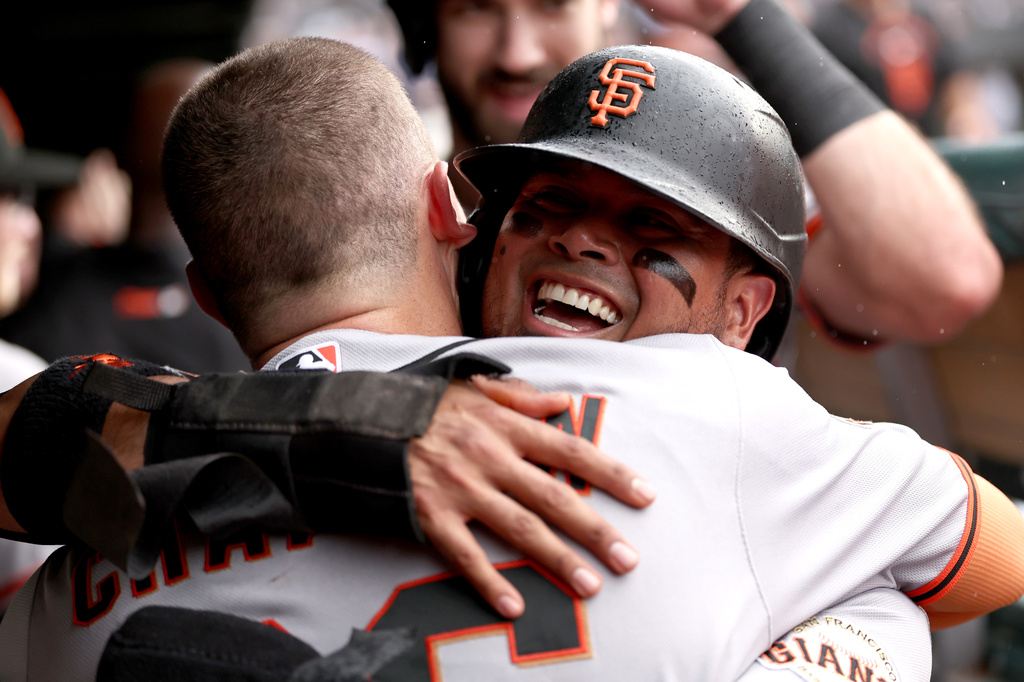 San Francisco Giants' Matt Chapman, back to camera, celebrates hitting a grand slam with Luis Arraez during the fourth inning of a baseball game against the Chicago Cubs at Wrigley Field, Friday, June 5, 2026, in Chicago. (AP Photo/Geoff Stellfox)