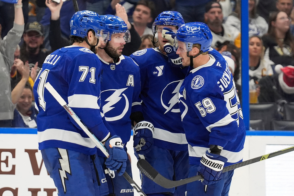 Tampa Bay Lightning right wing Nikita Kucherov, second from left, celebrates with teammates, including center Anthony Cirelli, left, and center Jake Guentzel, right, after scoring against the Pittsburgh Penguins during the second period of an NHL hockey game Thursday, Dec. 4, 2025, in Tampa, Fla. (AP Photo/Chris O'Meara)