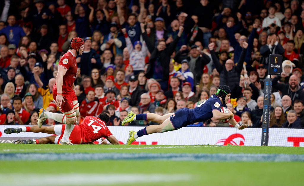Scotland's Huw Jones scores a try during the Six Nations rugby union match between Wales and Scotland in Cardiff, Wales, Saturday Feb. 21, 2026. (Nigel French/PA via AP)