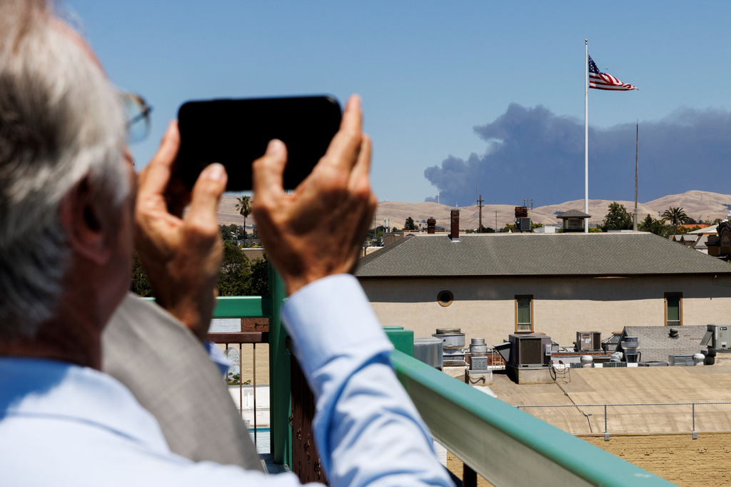 Livermore Mayor John Marchand takes a photo of smoke from a medical supply warehouse fire in Tracy, Calif., as seen from Livermore on Thursday, June 11, 2026. (Santiago Mejia/San Francisco Chronicle via AP)