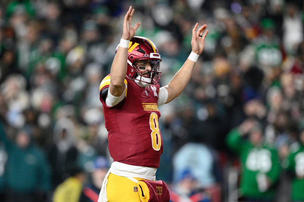 Washington Commanders quarterback Marcus Mariota celebrates after a touchdown by running back Jacory Croskey-Merritt during the first half of an NFL football game against the Philadelphia Eagles, Saturday, Dec. 20, 2025, in Landover, Md. (AP Photo/Nick Wass)
