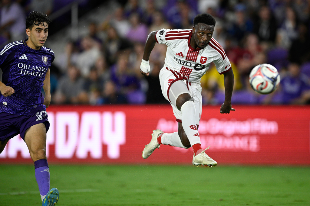 Toronto FC midfielder Derrick Etienne Jr., right, attempts a shot on goal as Orlando City defender Zakaria Taifi looks on during the first half of an MLS soccer match, Saturday, Sept. 12, 2026, in Orlando, Fla. (AP Photo/Phelan M. Ebenhack)