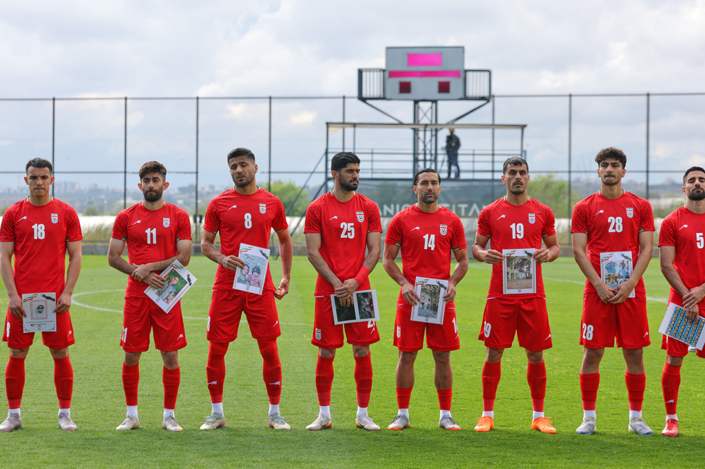 Iran's player pose for photographers holding pictures of children allegedly killed in a U.S. strikes in Iran, before a friendly soccer match between Iran and Costa Rica, in Antalya, southern Turkey, Tuesday, March 31, 2026. (AP Photo/Riza Ozel)