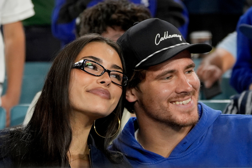FILE - Los Angeles Chargers quarterback Justin Herbert and girlfriend Madison Beer watch the Toronto Blue Jays and the Los Angeles Dodgers compete during the seventh inning in Game 3 of baseball's World Series, Monday, Oct. 27, 2025, in Los Angeles. (AP Photo/Ashley Landis, File)