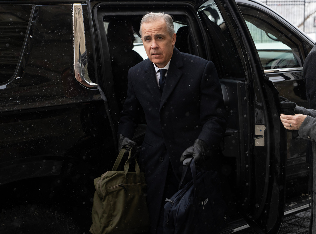 Canadian Prime Minister Mark Carney arrives by motorcade to Parliament Hill in Ottawa, Tuesday, Jan. 27, 2026. (Adrian Wyld/The Canadian Press via AP)