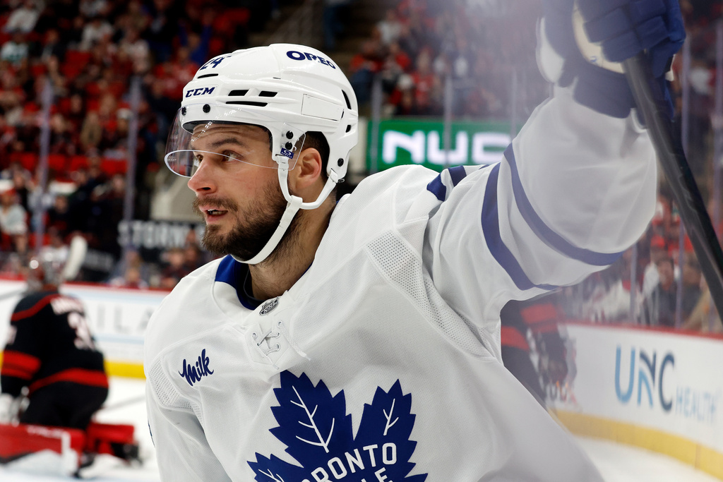 Toronto Maple Leafs' Scott Laughton (24) celebrates after his goal against the Carolina Hurricanes during the first period of an NHL hockey game in Raleigh, N.C., Thursday, Dec. 4, 2025. (AP Photo/Karl DeBlaker)