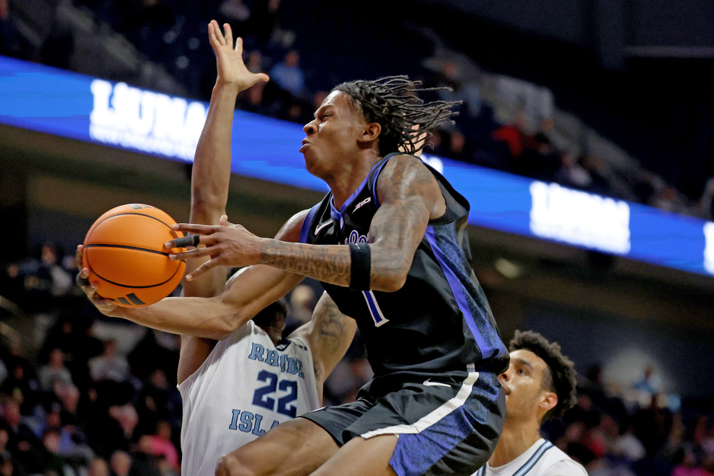 Saint Louis guard Quentin Jones, center, attempts a layup between Rhode Island guard RJ Johnson, left, and Rhode Island forward Keeyan Itejere during the first half of an NCAA college basketball game, Tuesday, Feb. 17, 2026, in South Kingstown, R.I. (AP Photo/Mark Stockwell)