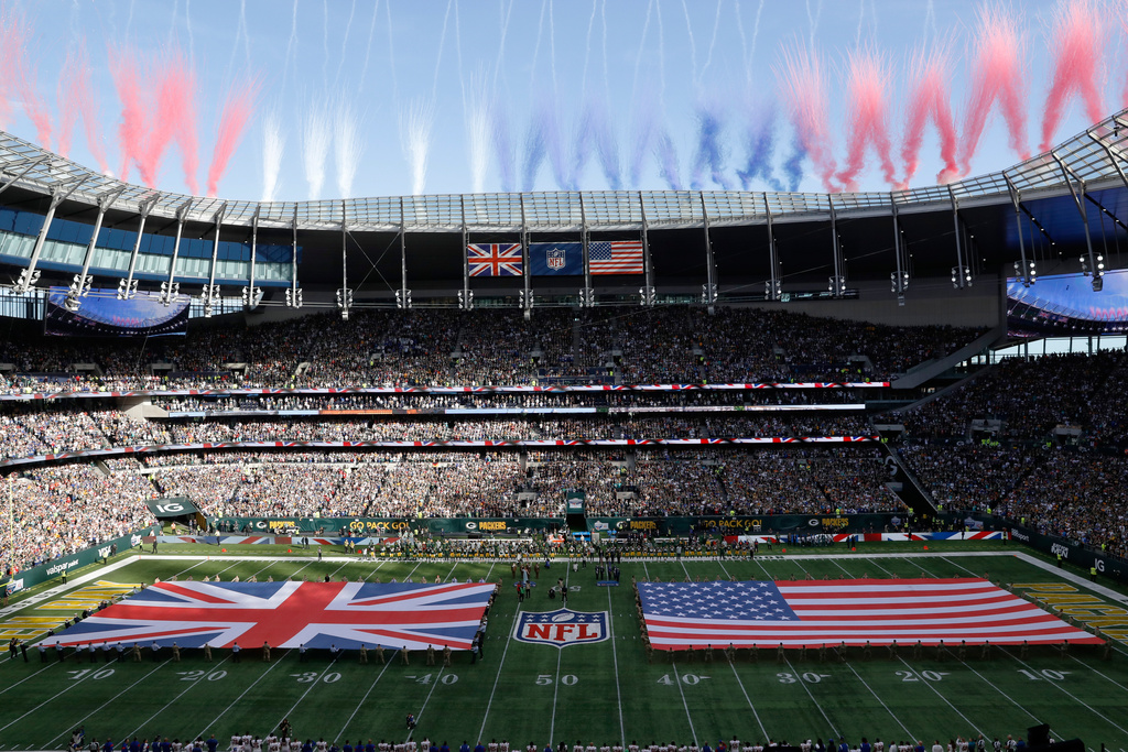 FILE - The Union Jack and United States flags are presented on the field during the singing of the national anthem before an NFL football game between the Green Bay Packers and the New York Giants at Tottenham Hotspur Stadium in London, on Oct. 9, 2022. (AP Photo/Steve Luciano, File)