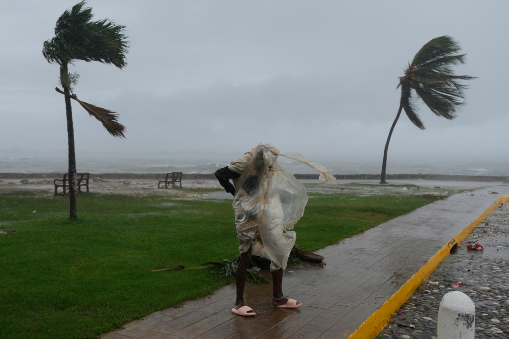 A man walks in Kingston, Jamaica, as Hurricane Melissa approaches, Tuesday, Oct. 28, 2025. (AP Photo/Matias Delacroix)