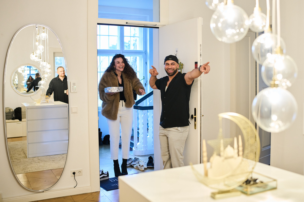 Gay Muslim influencer Ali Darwich, right, welcomes friends for an inclusive Iftar, the Ramadan fast-breaking meal, with friends who are Muslim, Christian, queer and straight, in Berlin, Germany, Wednesday, March 11, 2026. (AP Photo/Ebrahim Noroozi)