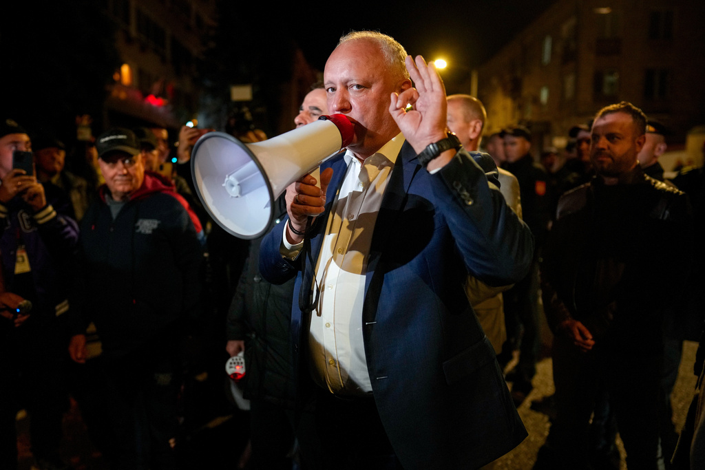 Former Moldovan President Igor Dodon, a member of the pro-Russian Patriotic Electoral Bloc, speaks to supporters protesting outside the Electoral Commission after the polls closed for the parliamentary election, in Chisinau, Moldova, Sunday, Sept. 28, 2025. (AP Photo/Vadim Ghirda)