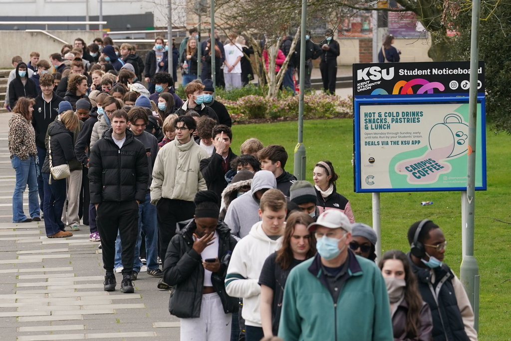 Students queue for antibiotics outside a building at the University of Kent, following an outbreak of meningitis, in Canterbury, Kent, England, Monday March 16, 2026. (Gareth Fuller/PA via AP)