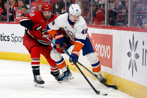 Carolina Hurricanes' Jordan Martinook (48) battles for the puck with New York Islanders' Matthew Schaefer (48) during the second period of an NHL hockey game in Raleigh, N.C., Thursday, Oct. 30, 2025. (AP Photo/Karl DeBlaker) Carolina Hurricanes' Jordan Martinook (48) battles for the puck with New York Islanders' Matthew Schaefer (48) during the second period of an NHL hockey game in Raleigh, N.C., Thursday, Oct. 30, 2025. (AP Photo/Karl DeBlaker)