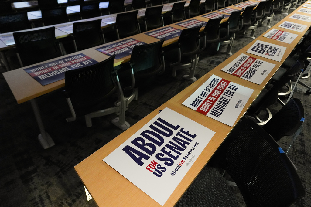 Posters lay on lecture hall tables before a campaign event with streamer Hasan Piker and Abdul El-Sayed, a progressive candidate in the Democratic primary for U.S. Senate in Michigan, Tuesday, April 7, 2026, at the University of Michigan in Ann Arbor, Mich. (AP Photo/Julia Demaree Nikhinson)
