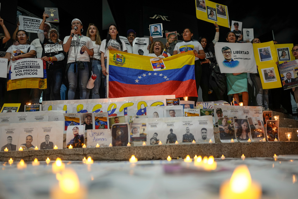Relatives of prisoners detained under former President Nicolás Maduro's rule hold a vigil calling for the release of their loved ones near El Helicoide, headquarters of Venezuela's intelligence service and a detention center, in Caracas, Venezuela, Saturday, Jan. 17, 2026. (AP Photo/Matias Delacroix)