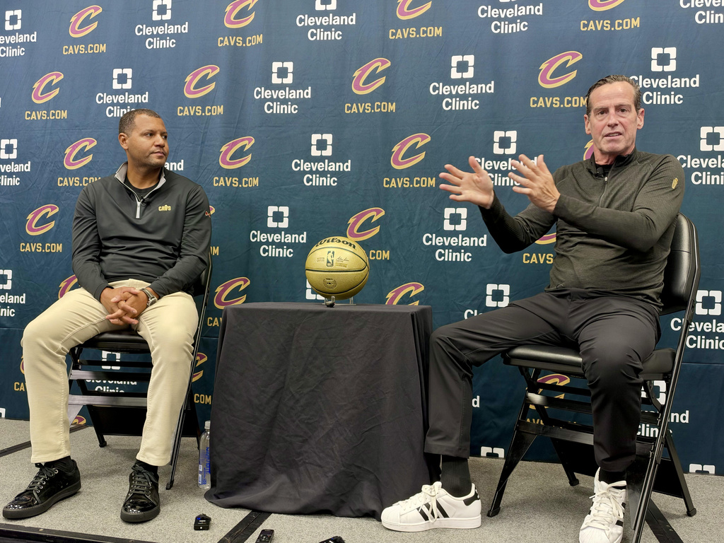 In this photo taken with a smartphone, Koby Altman, left, president of basketball operations for the Cleveland Cavaliers, and head coach Kenny Atkinson discuss the team's offseason moves and preview training camp during an NBA basketball news conference in Independence, Ohio, Friday, Sept. 25, 2026. (AP Photo/Joe Reedy)