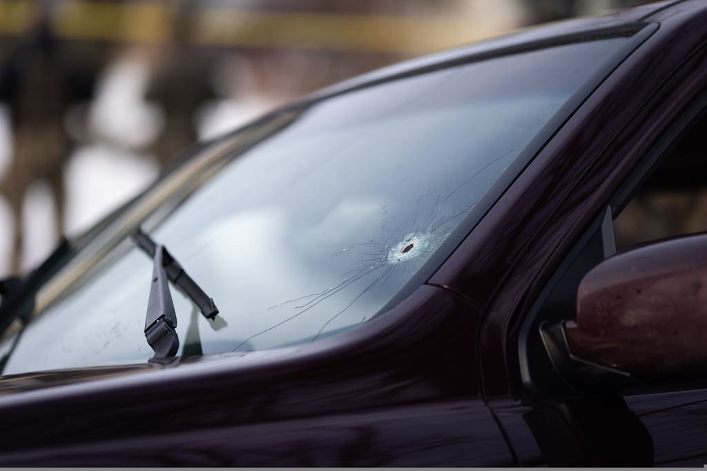 A bullet hole is seen on the windshield of a vehicle at the scene of a shooting in Minneapolis on Wednesday, Jan. 7, 2026. (Ben Hovland /Minnesota Public Radio via AP)
