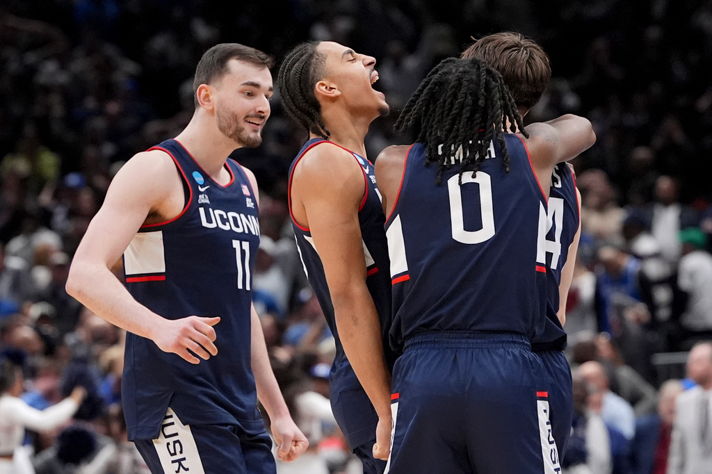 UConn guard Braylon Mullins, right, celebrates his game winning basket with guard Malachi Smith (0) during the second half in the Elite Eight of the NCAA college basketball tournament against Duke, Sunday, March 29, 2026, in Washington. (AP Photo/Stephanie Scarbrough)