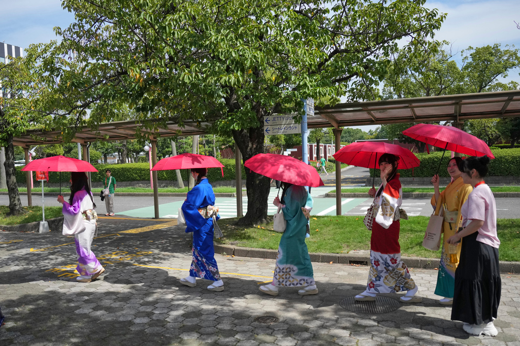 Women in traditional Japanese kimonos walk near the athletes village at the Asian Games in Nagoya, Japan, Friday, Sept. 18, 2026. (AP Photo/Dita Alangkara)