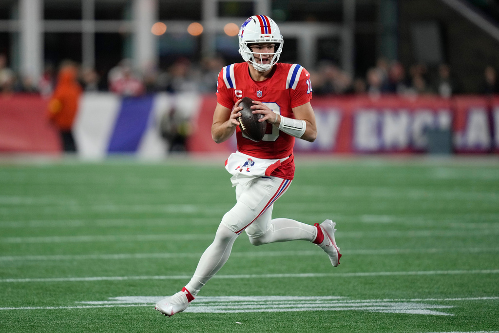 New England Patriots quarterback Drake Maye rolls out during the first half of an NFL football game against the New York Giants, Monday, Dec. 1, 2025, in Foxborough, Mass. (AP Photo/Charles Krupa)