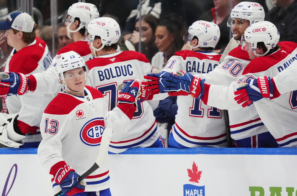 Montréal Canadiens right wing Cole Caufield (13) celebrates after his goal against the Toronto Maple Leafs with teammates on the bench during second-period NHL hockey game action in Toronto, Saturday, Dec. 6, 2025. (Frank Gunn/The Canadian Press via AP
