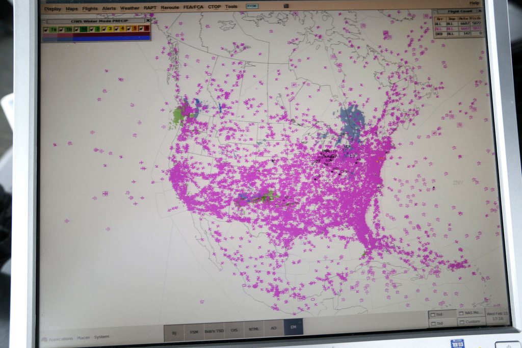 FILE - In this Wednesday, Feb. 11, 2015, photo, a computer screen shows all air traffic in real time over North America in the control tower at O'Hare International Airport in Chicago. (AP Photo/M. Spencer Green, File)