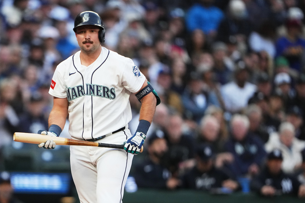 Seattle Mariners' Cal Raleigh walks to the dugout after striking out against the New York Yankees during the first inning of a baseball game, Tuesday, March 31, 2026, in Seattle. (AP Photo/Lindsey Wasson)