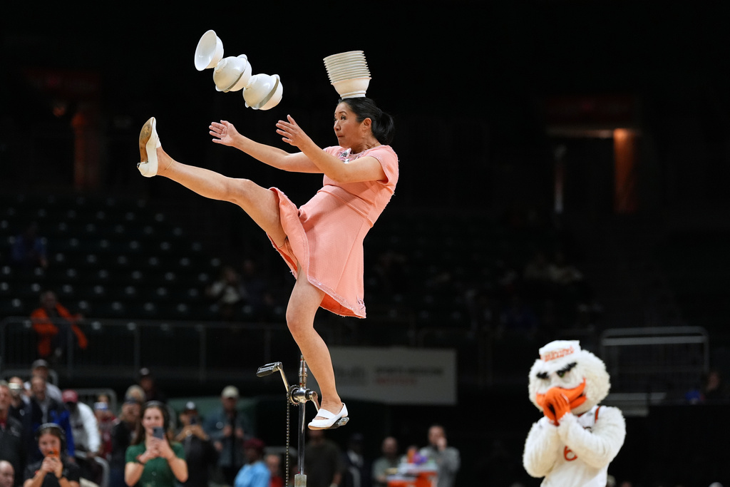 Red Panda performs as Miami's mascot Sebastian the Ibis looks on during halftime of an NCAA college basketball game between Miami and Stanford in Coral Gables, Fla., Wednesday, Jan. 28, 2026. (AP Photo/Rebecca Blackwell)