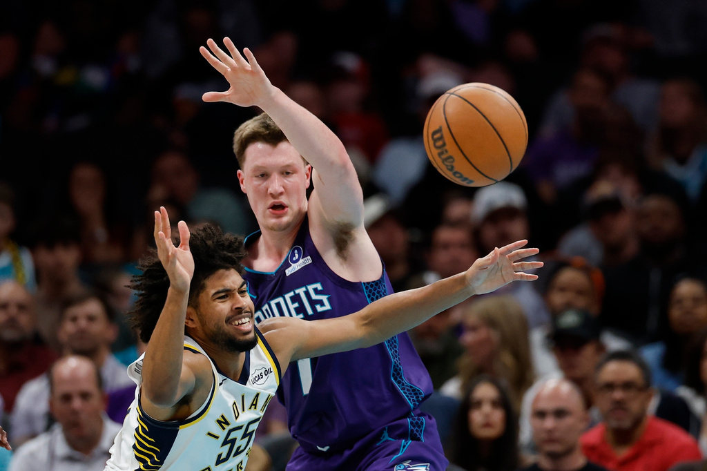 Indiana Pacers guard Ethan Thompson (55) battles Charlotte Hornets guard Kon Knueppel, right, for the ball during the first half of an NBA basketball game in Charlotte, N.C., Friday, April 3, 2026. (AP Photo/Nell Redmond)