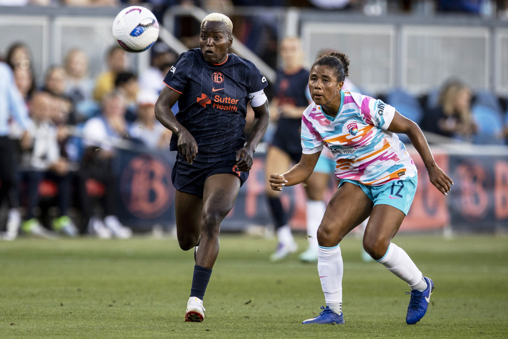 Bay FC forward Racheal Kundananji (9) and San Diego Wave FC defender Kennedy Wesley (12) chases after the ball during the first half of a NWSL soccer match in San Jose, Calif., Saturday, Aug. 16, 2025. (Stephen Lam/San Francisco Chronicle via AP)