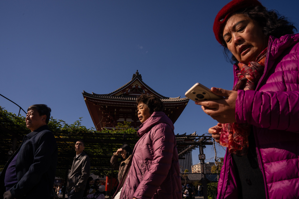 FILE - Mainland Chinese tourists visit Sensoji temple in the Asakusa district of Tokyo, Thursday, Nov. 20, 2025. (AP Photo/Louise Delmotte, File)