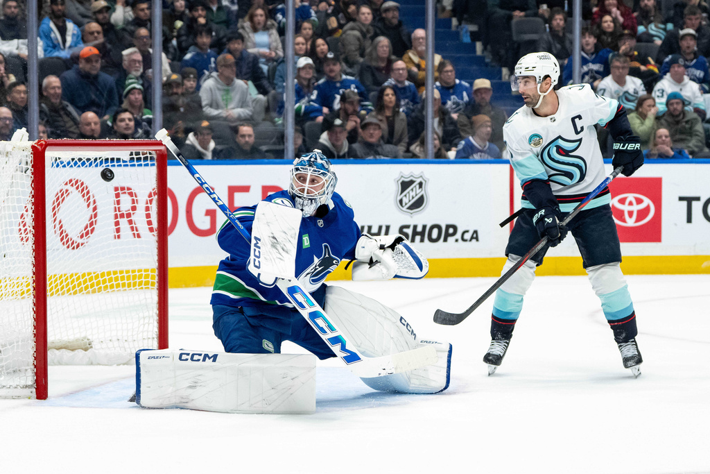 Seattle Kraken's Vince Dunn, not seen, scores a goal that was later disallowed, on Vancouver Canucks goaltender Thatcher Demko (35), as Seattle's Jordan Eberle (7) watches, during overtime NHL hockey action in Vancouver, Friday, Jan. 2, 2026. (Ethan Cairns/The Canadian Press via AP)