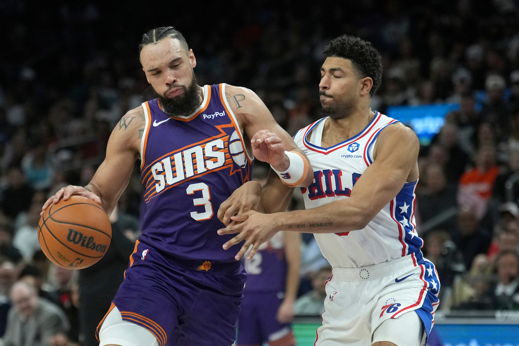 Phoenix Suns forward Dillon Brooks (3) dribbles the ball against Philadelphia 76ers guard Quentin Grimes during the second half of an NBA basketball game Saturday, Feb. 7, 2026, in Phoenix. (AP Photo/Ross D. Franklin)
