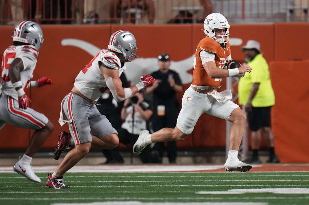Texas quarterback Arch Manning (16) scramble against Ohio State during the first half of an NCAA college football game in Austin, Texas, Saturday, Sept. 12, 2026. (AP Photo/Eric Gay)