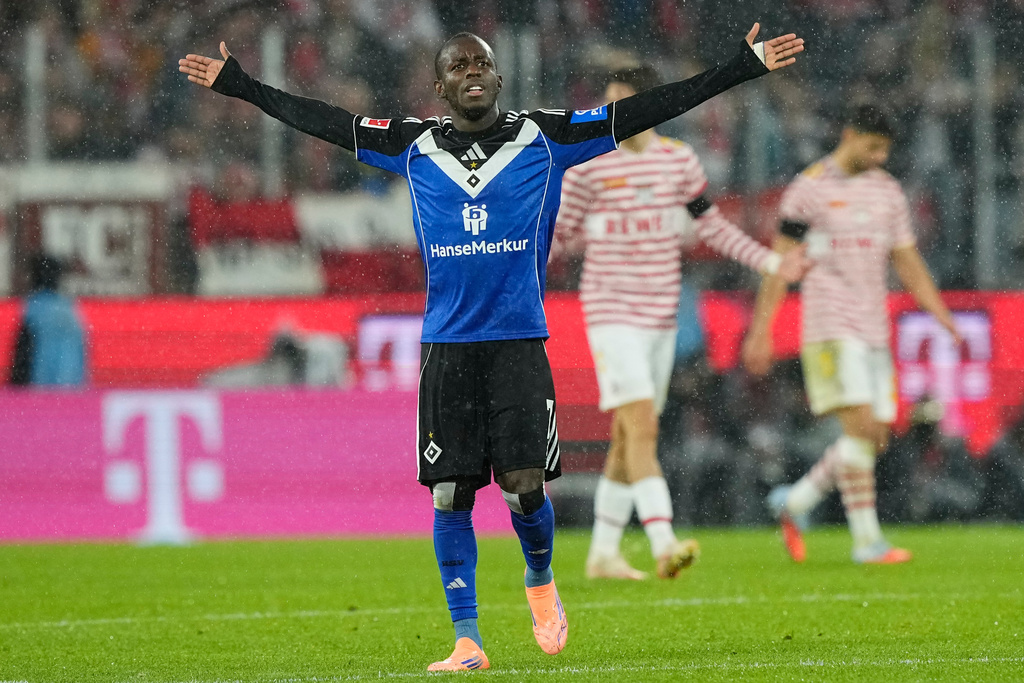 Hamburg's Jean-Luc Dompe celebrates after scoring his side's opening goal during the German Bundesliga soccer match between Cologne and Hamburger SV, in Cologne, Germany, Sunday, Nov. 2, 2025. (AP Photo/Martin Meissner)