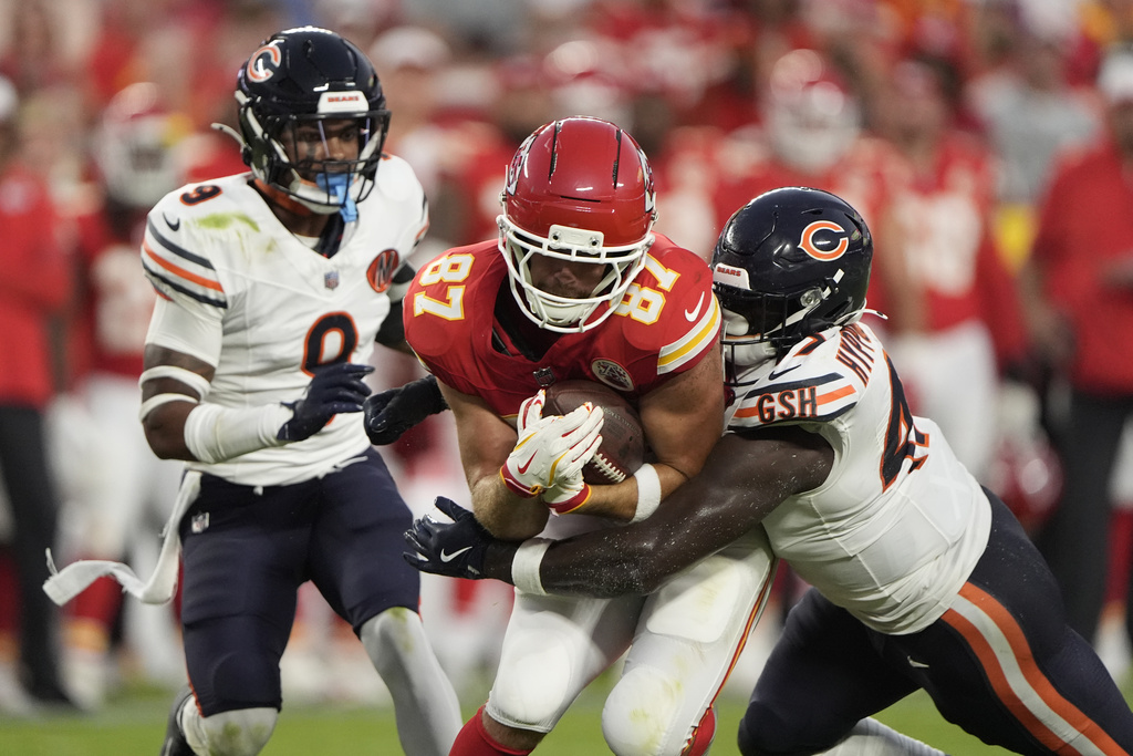Kansas City Chiefs tight end Travis Kelce (87) is stopped by Chicago Bears linebacker Ruben Hyppolite II, right, as defensive back Jaquan Brisker (9) watches during the first half of a preseason NFL football game Friday, Aug. 22, 2025, in Kansas City, Mo. (AP Photo/Charlie Riedel)