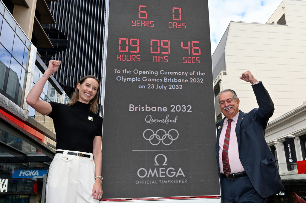 Australian Olympian Emma McKeon, left, and Brisbane 2032 Organising Committee President Andrew Liveris pose at the unveiling of the count-down clock marking six years until the Brisbane 2032 Olympics, in Brisbane, Australia, Thursday, July 23, 2026. (Darren England/AAP Image via AP)