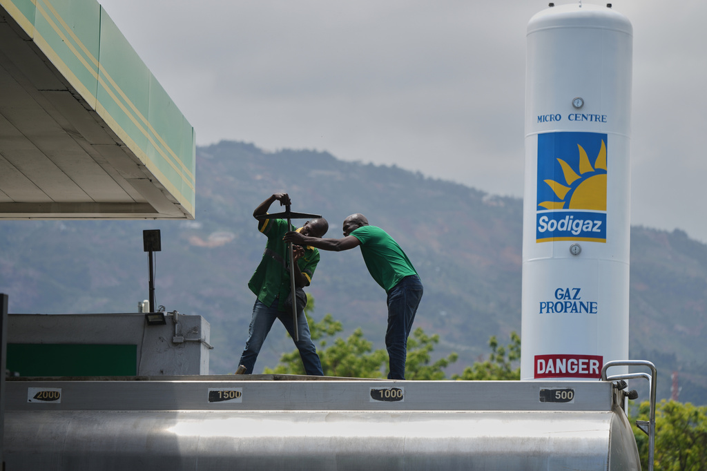Gas station employees prepare to fill a tank with gas in Port-au-Prince, Haiti, Tuesday, April 7, 2026. (AP Photo/Odelyn Joseph)
